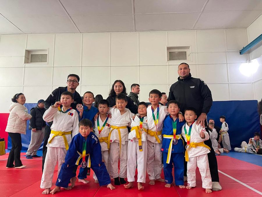 U Champ students with coaches and medals