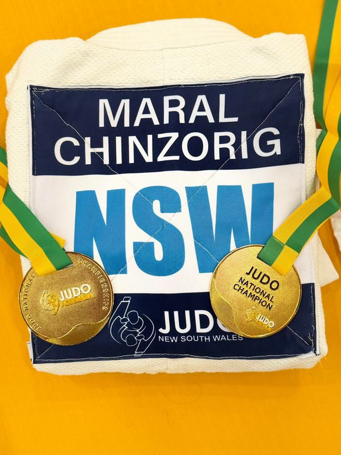 Judo NSW national champion medals on a student's gi