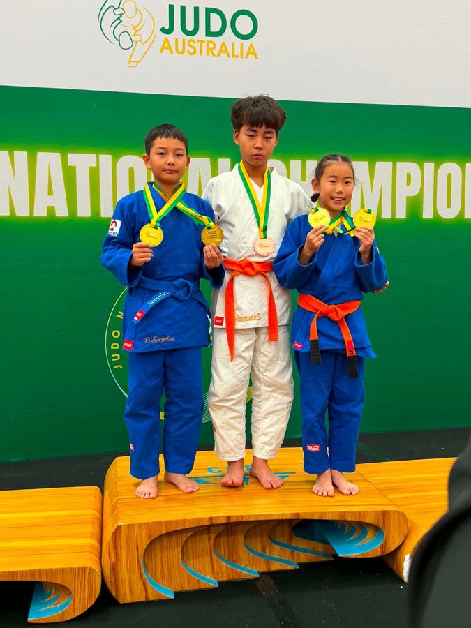 U Champ students on the podium with medals